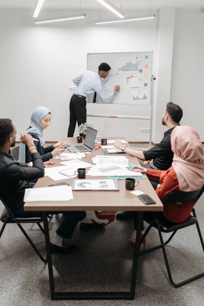 An office team of mixed ethnicities collaborating in a modern meeting room.